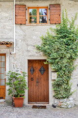 Wooden front door and window in Limone sul Garda, Italy.