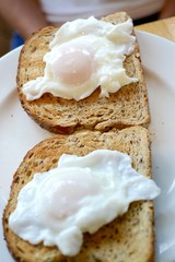 Poached eggs on brown toast 