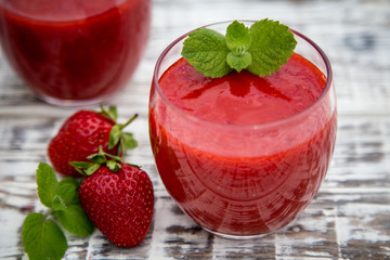 strawberry smoothie on a light wooden background