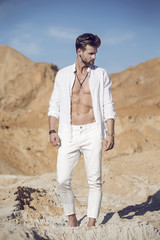 Handsome sexy man in the desert