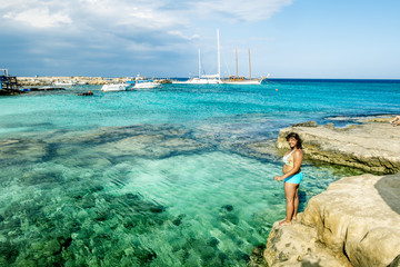 Girl in swimsuit posing on the beautiful beach of Protaras.Cypru