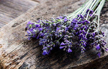 Bunch of lavender flowers on a wooden background.