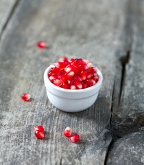 pomegranate seeds on wooden surface