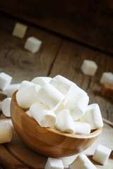 Large marshmallows in a wooden bowl, selective focus