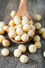 salted macadamia nuts on wooden surface
