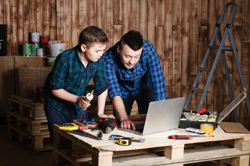 construction of father and son in the garage, family concept