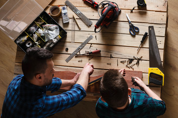 construction of father and son in the garage, family concept vie