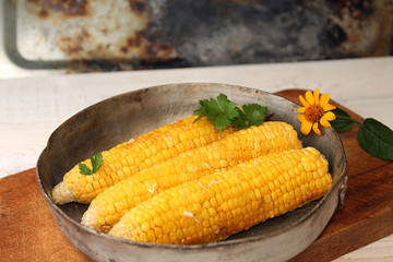 Corn baked in oven with butter and garlic