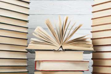 Open book, hardback books on wooden table. Education background. Back to school. Copy space for text.