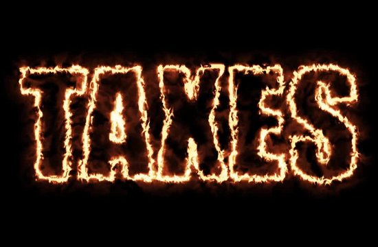 Taxes tag from hot burning letters on black background in 4K ultra HD