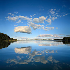Naklejka na ściany i meble Calm Lake in Summer Landscape, Reflection of Blue Sky with Clouds