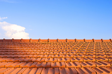 Tile-roofed house on the sky background