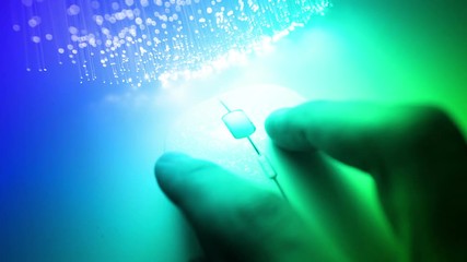 person using the mouse with Fiber optics background, shot in HD