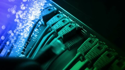 Ethernet cable and server with Fiber optics background, shot in HD