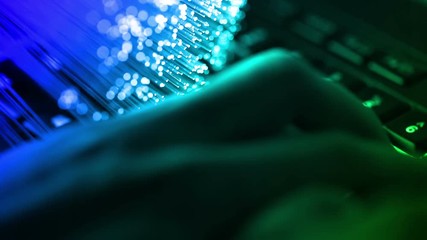 typing on keyboard with Fiber optics background, shot in HD