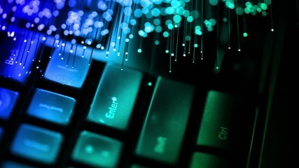 computer keyboard with Fiber optics background, shot in HD