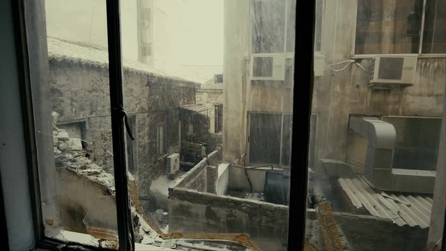 4K Window view at collapsed, half-ruined buildings in ghetto city block