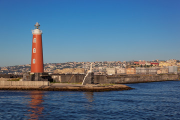 Fototapeta na wymiar Lighthouse at harbour in Naples, Italy, Europe