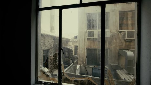 4K Window view at collapsed, half-ruined buildings in ghetto city block