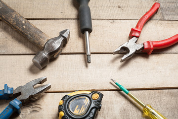 Construction tools on wooden background. Copy space for text. Set of assorted work tool at wood table . Top view