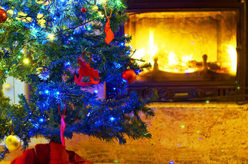 Christmas tree decorated with ornaments and fireplace background