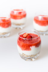 strawberry dessert with biscuits in a glass, shallow depth of fi