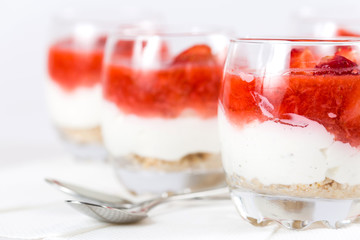 strawberry dessert with biscuits in a glass, shallow depth of fi
