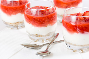 strawberry dessert with biscuits in a glass, shallow depth of fi