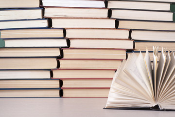 Open book, hardback books on wooden table. Education background. Back to school. Copy space for text.