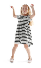 Cheerful little girl dancing on white background