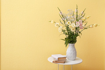 Beautiful flower bouquet on yellow wall background
