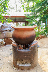 Fototapeta premium decocting medicinal herbs with earthen pot 