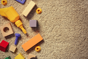 Children's toys on carpet, top view