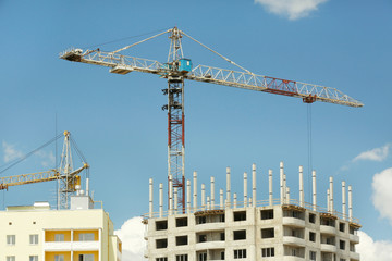 Fototapeta na wymiar Crane and building construction on sky background