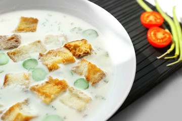 Tasty asparagus soup with crackers on table