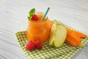 Tasty smoothie drink with vegetables and fruits on table