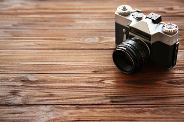 Retro camera on wooden background