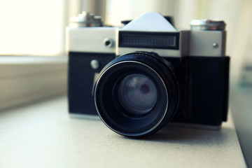 Retro camera on windowsill closeup