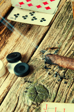 Cards and chips on old wooden background