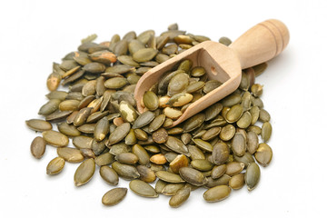 pumpkin seeds in a wooden scoop