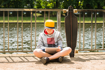 Boy Wearing Cap Using Digital Tablet