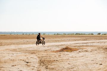 Man rides his motorcycle through the desert