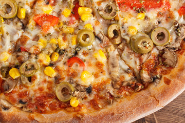 Vegetarian pizza on rustic wooden background, fast food