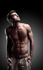 Fototapeta na wymiar a young male model posing his muscles