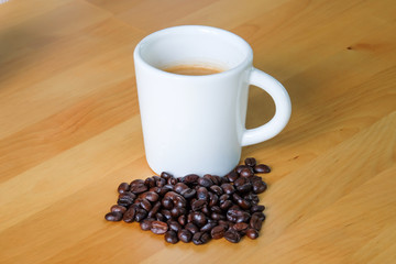 Coffee Cup and Beans on Wooden Table