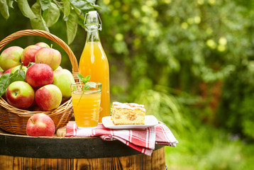 Apples and apple preserves on a barrel on the background of the
