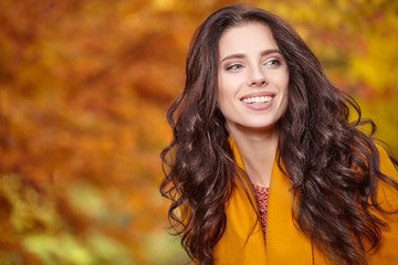 Beautiful young woman in autumn styling on the background of aut