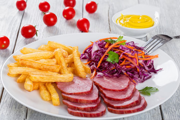 french fries and sliced smoked veal with cabbage salad