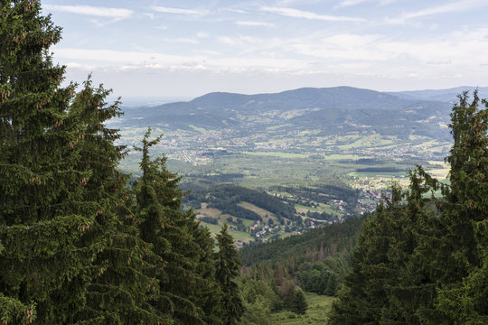Fototapeta Mountain landscape with the town in the valley.