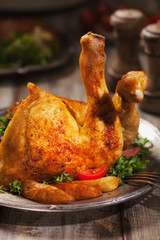 Baked chicken leg, served with roasted potatoes and vegetables.